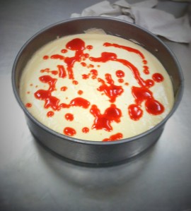 Lemon cheesecake with strawberry puree drizzle